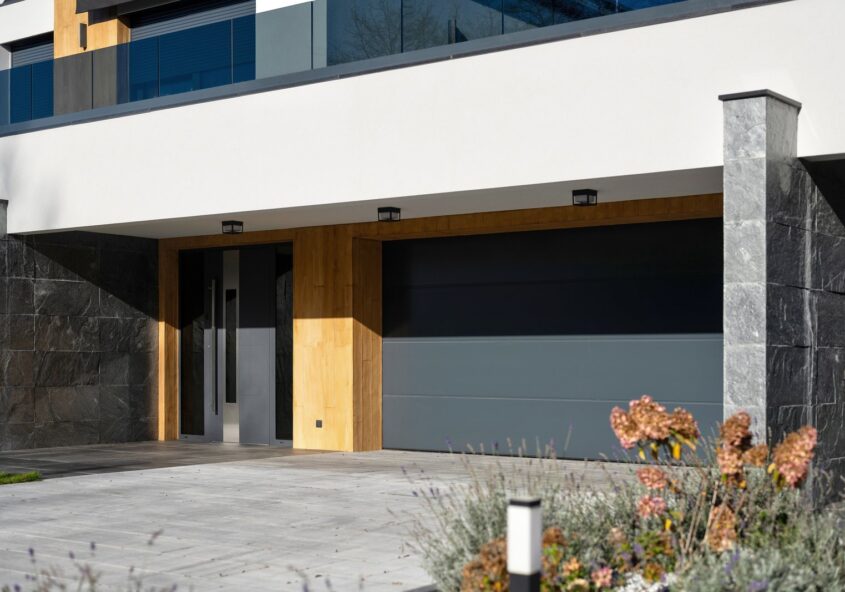 Come progettare il garage WIŚNIOWSKI, facciata casa moderna con portone coordinato